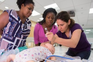 Carolina First Look students practice intubating children in CPR simulation